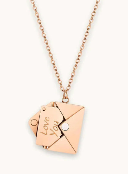 Rose gold necklace with envelope pendant revealing a card engraved with Love You message