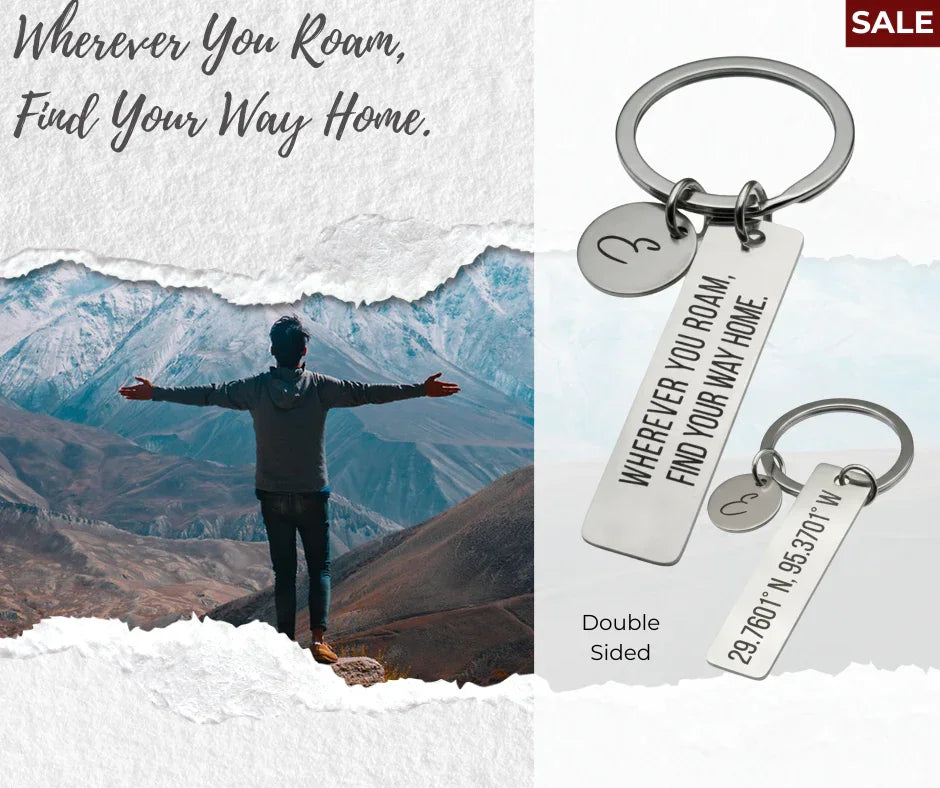 Keychain with engraved quote 'Wherever You Roam, Find Your Way Home' and coordinates, shown with mountain landscape and person outdoors
