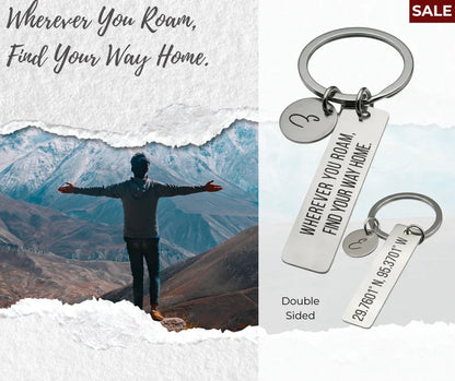 Keychain with engraved quote 'Wherever You Roam, Find Your Way Home' and coordinates, shown with mountain landscape and person outdoors