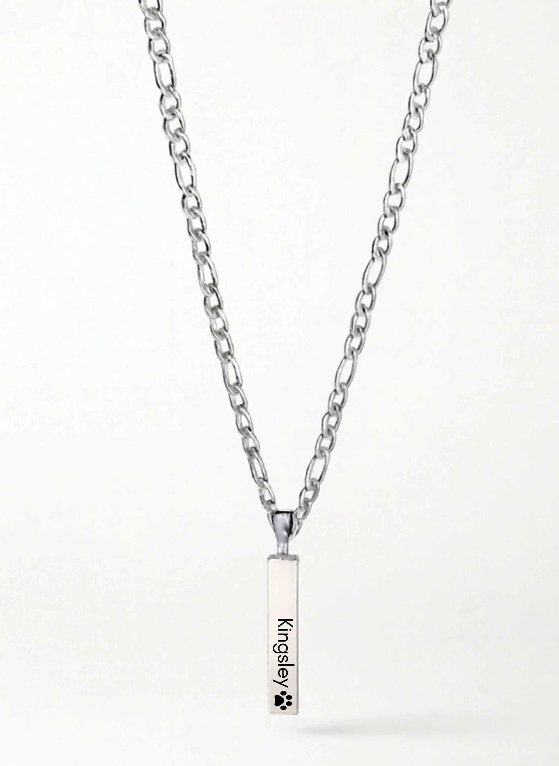 Silver chain necklace with rectangular pendant engraved 'Kingsley' and a paw print symbol